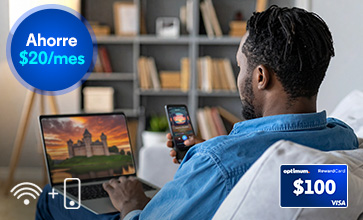 Man in denim seen from behind looks at a laptop and phone in a study; WiFi-plus-phone icon and $100 Visa card